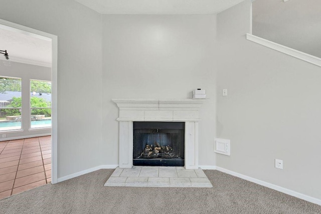 interior details with baseboards, a fireplace with raised hearth, and carpet