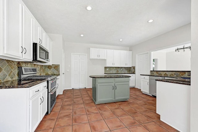 kitchen featuring decorative backsplash, light tile patterned floors, stainless steel appliances, white cabinets, and recessed lighting