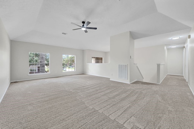 unfurnished living room with plenty of natural light, baseboards, carpet, and ceiling fan