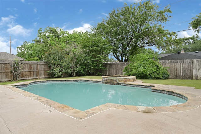 view of pool with a fenced backyard, a pool with connected hot tub, and a patio