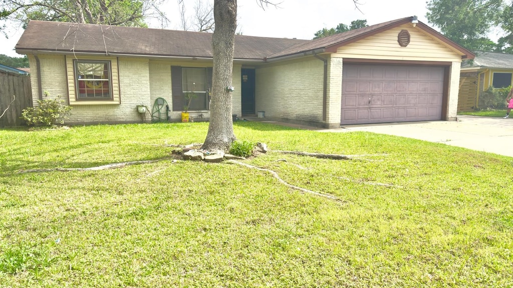 ranch-style home with brick siding, a front lawn, concrete driveway, and a garage