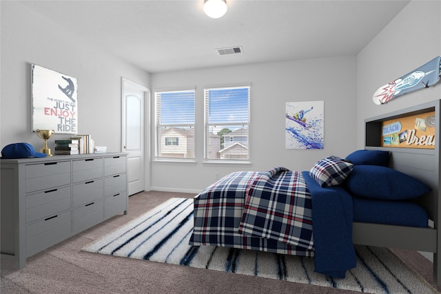 bedroom with visible vents, baseboards, and light carpet