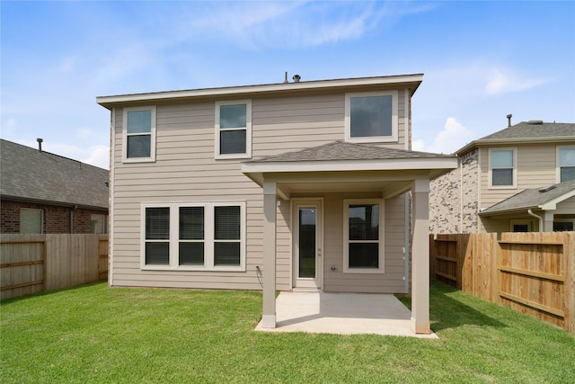 back of house with a patio area, a lawn, and a fenced backyard