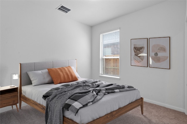 carpeted bedroom with baseboards and visible vents
