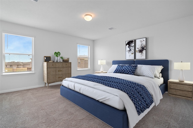 carpeted bedroom with visible vents and baseboards