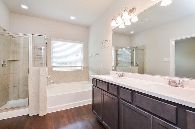 24430 Vittorio Wood Ln, Katy, TX 77493 - bathroom with a stall shower, wood finished floors, a garden tub, double vanity, and recessed lighting