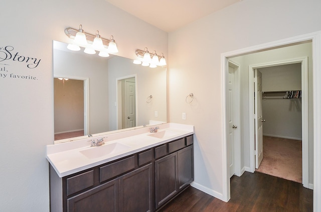 24430 Vittorio Wood Ln, Katy, TX 77493 - bathroom with wood finished floors, double vanity, and baseboards