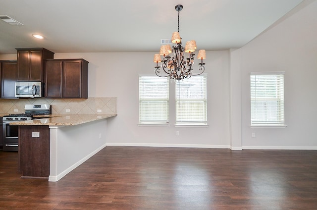24430 Vittorio Wood Ln, Katy, TX 77493 - kitchen with appliances with stainless steel finishes, a chandelier, dark brown cabinets, tasteful backsplash, and dark wood-type flooring
