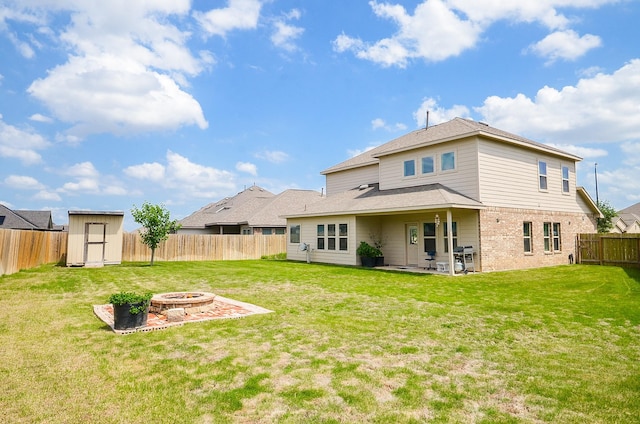 24430 Vittorio Wood Ln, Katy, TX 77493 - rear view of property with a fire pit, a shed, brick siding, a patio, and an outdoor structure