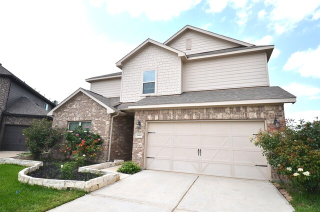 24430 Vittorio Wood Ln, Katy, TX 77493 - view of front of property featuring driveway, brick siding, an attached garage, and roof with shingles