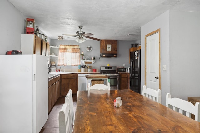 kitchen with freestanding refrigerator, open shelves, dishwashing machine, and stainless steel gas stove