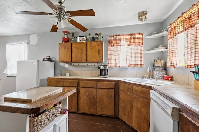 kitchen with open shelves, a ceiling fan, tile countertops, a sink, and white appliances