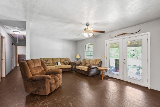 living room with attic access, french doors, a textured ceiling, and ceiling fan