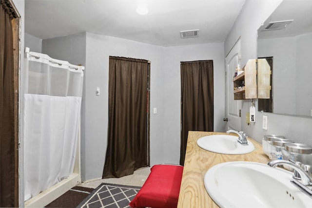 full bathroom with visible vents, a sink, and a stall shower