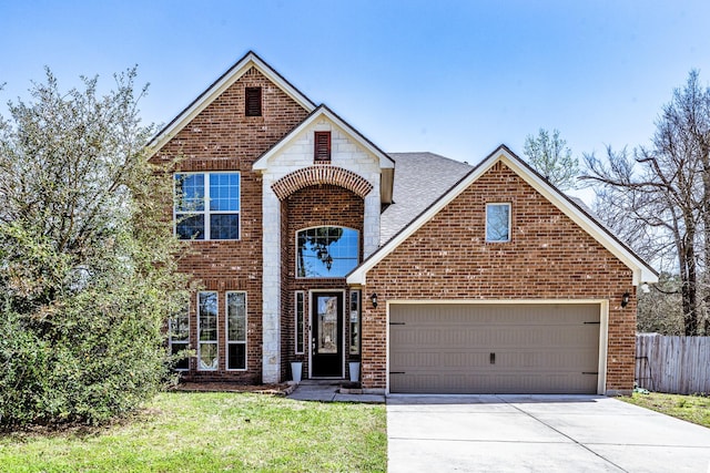 3713 Daisy Ln, Huntsville, TX 77340 - traditional home with driveway, an attached garage, fence, a front yard, and brick siding