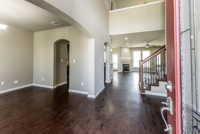 3713 Daisy Ln, Huntsville, TX 77340 - entrance foyer with arched walkways, dark wood-type flooring, visible vents, and baseboards