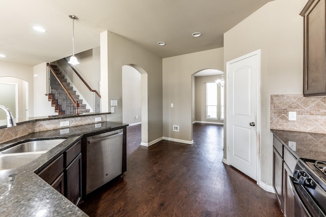 3713 Daisy Ln, Huntsville, TX 77340 - kitchen with black range with gas stovetop, decorative backsplash, dishwasher, arched walkways, and dark wood-style floors