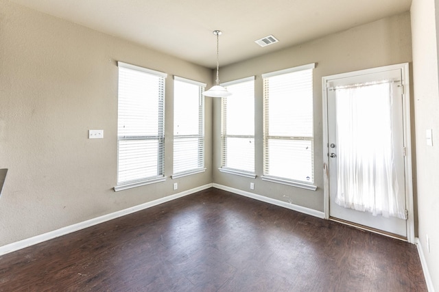 3713 Daisy Ln, Huntsville, TX 77340 - unfurnished dining area with visible vents, baseboards, and dark wood-style flooring