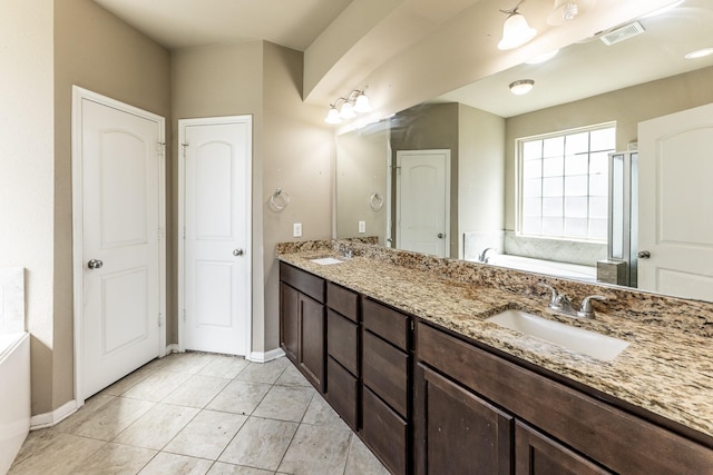 3713 Daisy Ln, Huntsville, TX 77340 - bathroom with a garden tub, a sink, visible vents, and baseboards