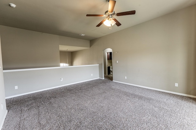3713 Daisy Ln, Huntsville, TX 77340 - carpeted spare room with arched walkways, baseboards, and ceiling fan