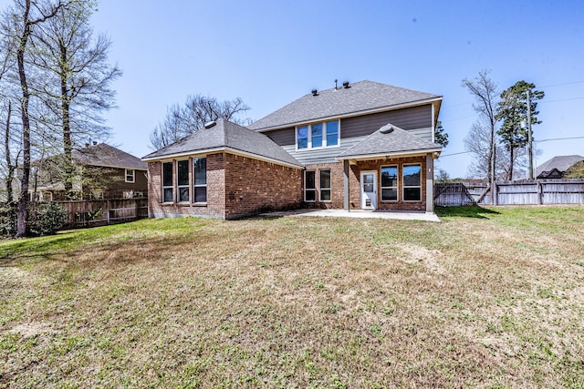 3713 Daisy Ln, Huntsville, TX 77340 - back of house featuring a fenced backyard, brick siding, a patio area, a shingled roof, and a yard