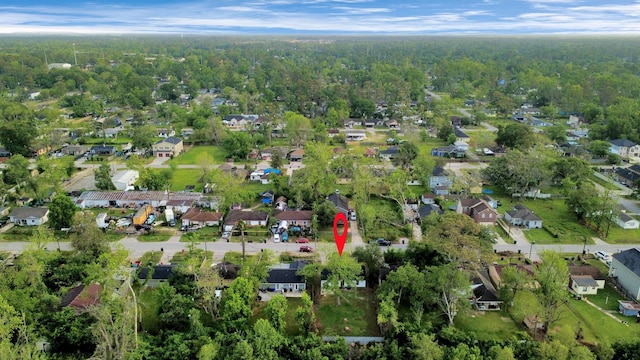 aerial view featuring a wooded view and a residential view