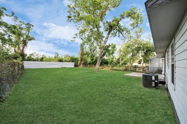 view of yard featuring central AC unit and a fenced backyard