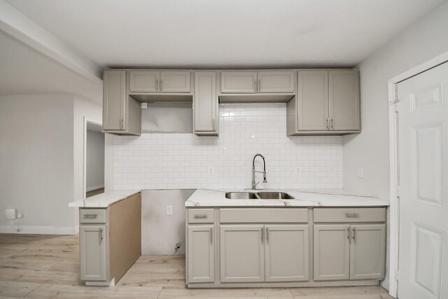 8014 Crestview Dr, Houston, TX 77028 - kitchen with gray cabinetry, tasteful backsplash, and light stone counters
