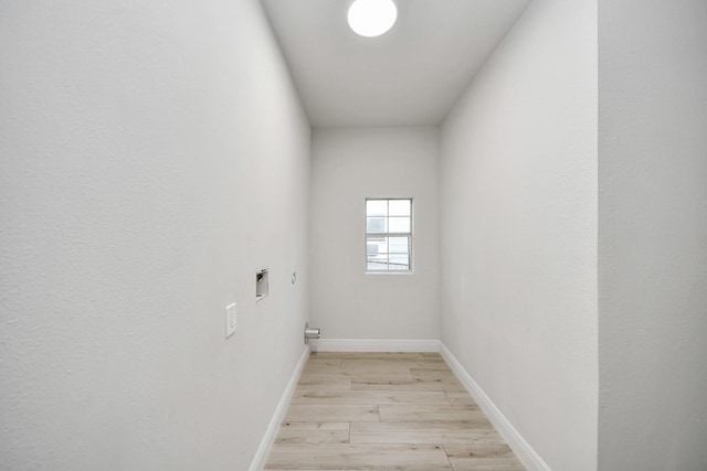 laundry room featuring light wood-style floors, washer hookup, baseboards, and laundry area