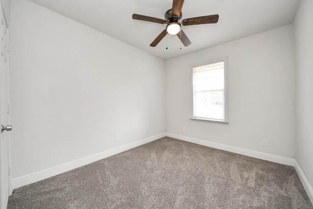 carpeted spare room with baseboards and ceiling fan