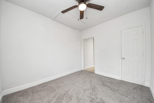 unfurnished bedroom featuring carpet floors, baseboards, and attic access