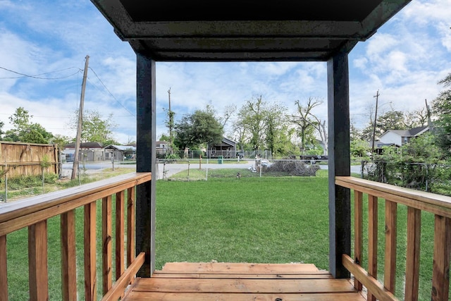 wooden deck with a fenced backyard and a yard
