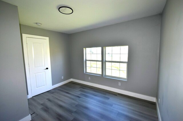 504 Cedar St, Sweeny, TX 77480 - empty room with baseboards, dark wood finished floors, and a smoke detector