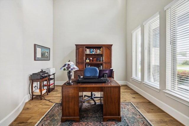 6605 Rolla St, Houston, TX 77055 - office area featuring baseboards, light wood-style floors, and a towering ceiling