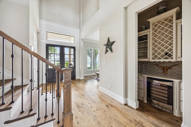 6605 Rolla St, Houston, TX 77055 - foyer entrance with wine cooler, a high ceiling, a bar, and stairs
