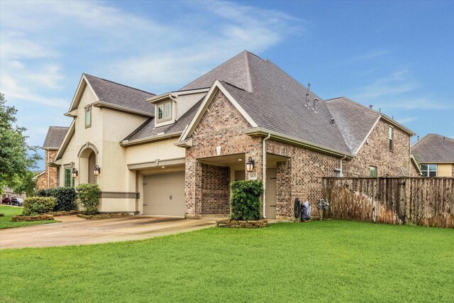 8207 Mesquite Hill Ln, Richmond, TX 77469 - view of front of house with a front yard, fence, concrete driveway, a shingled roof, and stucco siding