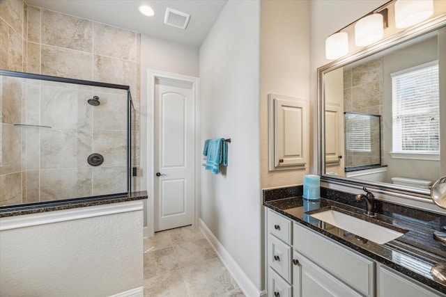 8207 Mesquite Hill Ln, Richmond, TX 77469 - full bath with visible vents, baseboards, vanity, and tiled shower