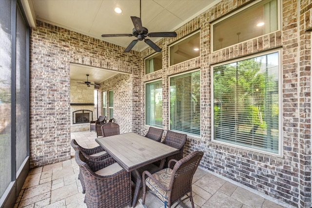 8207 Mesquite Hill Ln, Richmond, TX 77469 - sunroom with an outdoor stone fireplace, a ceiling fan, and outdoor dining area