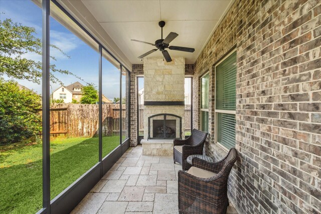 8207 Mesquite Hill Ln, Richmond, TX 77469 - sunroom / solarium with ceiling fan and an outdoor stone fireplace