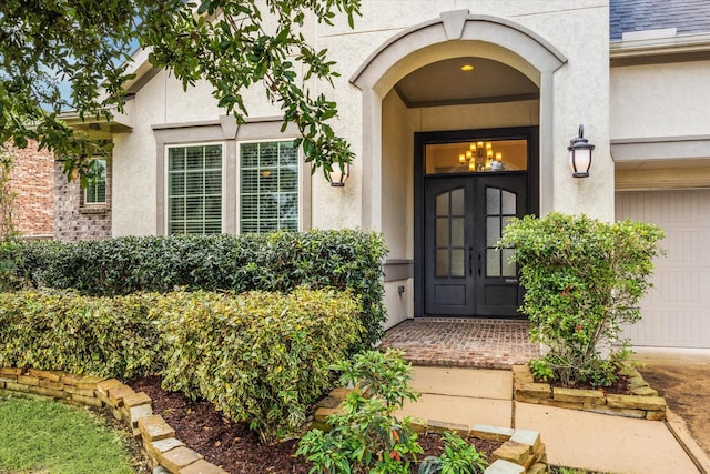 8207 Mesquite Hill Ln, Richmond, TX 77469 - entrance to property with french doors, stucco siding, and a garage