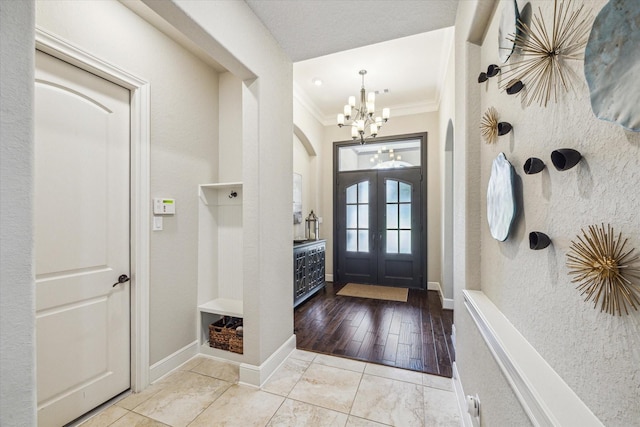 8207 Mesquite Hill Ln, Richmond, TX 77469 - foyer with crown molding, arched walkways, baseboards, and a notable chandelier