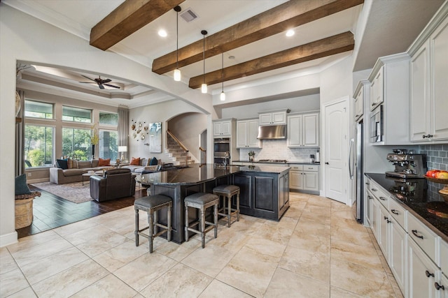 8207 Mesquite Hill Ln, Richmond, TX 77469 - kitchen featuring a ceiling fan, arched walkways, backsplash, and open floor plan