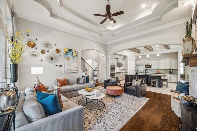 8207 Mesquite Hill Ln, Richmond, TX 77469 - living area featuring crown molding, dark wood-style flooring, stairs, arched walkways, and a ceiling fan