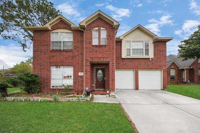 traditional-style house with brick siding, an attached garage, driveway, and a front lawn