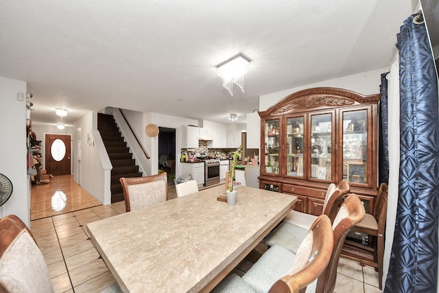 dining space with light tile patterned flooring and stairway