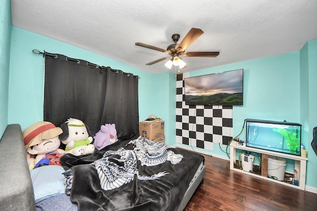 bedroom featuring wood finished floors, a textured ceiling, and ceiling fan