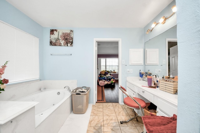 bathroom featuring vanity, marble finish floor, and a tub with jets