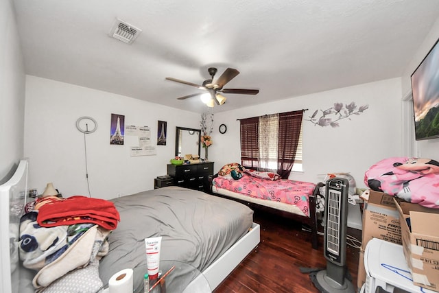bedroom featuring visible vents, hardwood / wood-style flooring, and ceiling fan