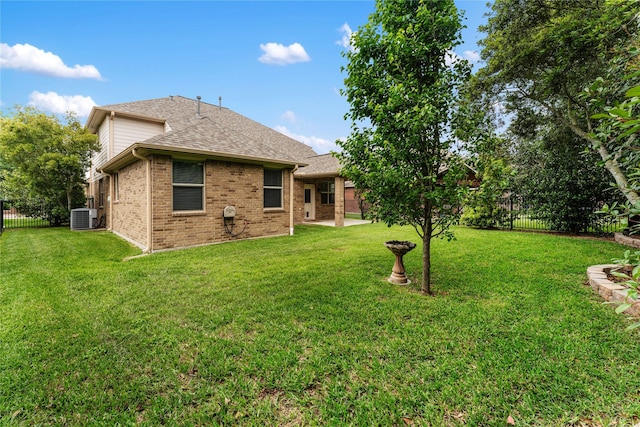18823 Cove Mill Ln, Cypress, TX 77433 - rear view of property featuring a fenced backyard, brick siding, and a shingled roof