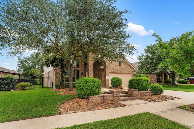 view of front of property with fence, brick siding, a front yard, and a garage